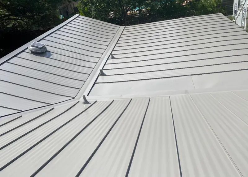 Solar attic fan installed on a metal roof for Roof Ventilation in Credit River